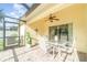 Enclosed patio features a table, chairs, and views of the backyard at 13194 Royal Pines Ave, Riverview, FL 33579
