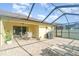 Enclosed patio with lounge chairs, grill, and a view of the backyard at 13194 Royal Pines Ave, Riverview, FL 33579