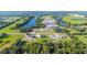 Aerial perspective features four upscale homes, with manicured landscaping, and verdant surrounding views at 14080 Sydney Rd, Dover, FL 33527