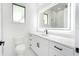 Clean bathroom with large, lighted mirror and white vanity with drawers for ample storage at 14080 Sydney Rd, Dover, FL 33527