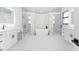Luxurious bathroom with dual vanities, walk-in shower, and a freestanding soaking tub at 14080 Sydney Rd, Dover, FL 33527