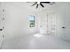 Bright bedroom features white walls, tile floors, and a modern ceiling fan at 14080 Sydney Rd, Dover, FL 33527