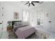 Staged bedroom features a stylish bed, nightstand, rug, and window with curtains at 14080 Sydney Rd, Dover, FL 33527