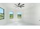 Spacious bedroom with white walls, tile floors, and plenty of natural light at 14080 Sydney Rd, Dover, FL 33527