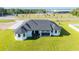 New construction featuring a modern house with a dark roof in a landscaped yard at 14080 Sydney Rd, Dover, FL 33527