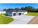 Exterior angle of a home with a two car garage and spacious driveway at 14080 Sydney Rd, Dover, FL 33527