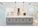 Bright kitchen with a large island, stainless steel appliances and white and gray cabinetry at 14080 Sydney Rd, Dover, FL 33527