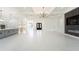 Open living space with tile floors, modern kitchen, eye-catching light fixtures and tray ceilings at 14080 Sydney Rd, Dover, FL 33527