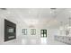 Large living area with tile floors, lots of natural light, and a modern kitchen at 14080 Sydney Rd, Dover, FL 33527