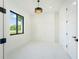 Bright and airy office space featuring white tile floors, modern lighting, and a large window at 14080 Sydney Rd, Dover, FL 33527