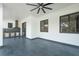 Covered patio features an outdoor kitchen, dark-trimmed windows, and tiled flooring at 14080 Sydney Rd, Dover, FL 33527