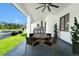 Covered patio showcases an outdoor kitchen, seating, and a view of the backyard at 14080 Sydney Rd, Dover, FL 33527