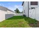 The spacious backyard is enclosed by a white privacy fence and has a healthy lawn, offering an ideal outdoor space at 1500 49Th N St, St Petersburg, FL 33710