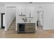 Stylish bar area with a wine cooler, white cabinets and tiled backsplash, adjacent to the staircase at 1500 49Th N St, St Petersburg, FL 33710