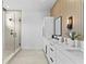 Modern bathroom with glass enclosed shower and double sink vanity with black hardware at 1500 49Th N St, St Petersburg, FL 33710