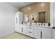 Modern bathroom featuring dual sinks, marble countertops, and a stylish, ribbed accent wall at 1500 49Th N St, St Petersburg, FL 33710