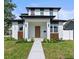 Modern two-story home featuring a manicured lawn, clean lines, and a contemporary front door and entrance at 1500 49Th N St, St Petersburg, FL 33710