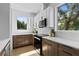 Modern kitchen with stainless appliances, stone countertops, subway tile, and wood cabinets with lots of light at 1500 49Th N St, St Petersburg, FL 33710