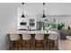Contemporary kitchen island with seating, pendant lights and stainless appliances, connecting to living area at 1500 49Th N St, St Petersburg, FL 33710