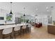 Open-concept kitchen flows into the living room, with a large island, stainless steel appliances, and hardwood floors at 1500 49Th N St, St Petersburg, FL 33710