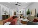 Open living area with hardwood floors, modern lighting, and access to kitchen and dining room at 1500 49Th N St, St Petersburg, FL 33710