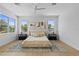Spacious main bedroom with hardwood floors, large windows, and neutral decor at 1500 49Th N St, St Petersburg, FL 33710