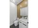 Stylish powder room with modern fixtures, vanity, and a unique textured accent wall for a sophisticated touch at 1500 49Th N St, St Petersburg, FL 33710