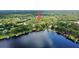 Aerial view of the home with boat docks on the lake amidst green trees at 16006 Armistead Ln, Odessa, FL 33556