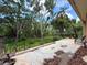 Spacious covered patio with scenic view of lush backyard and mature trees at 16006 Armistead Ln, Odessa, FL 33556