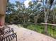 A patio featuring old brick tiles and a view of the surrounding yard and trees at 16006 Armistead Ln, Odessa, FL 33556