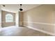 Cozy bedroom features a large window, neutral paint, and newly finished floors at 16006 Armistead Ln, Odessa, FL 33556