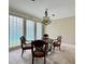 Formal dining area with glass block windows and vintage chandelier at 16006 Armistead Ln, Odessa, FL 33556