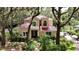 Inviting home boasts a red tile roof and mature landscaping, creating a private, serene setting at 16006 Armistead Ln, Odessa, FL 33556