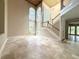 Bright and airy foyer with high ceilings, grand staircase, and tiled floors at 16006 Armistead Ln, Odessa, FL 33556
