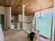 Bright hallway featuring wooden ceilings, staircase, and glass block wall at 16006 Armistead Ln, Odessa, FL 33556