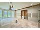 Spacious kitchen area ready for renovation with large windows and a modern lighting fixture at 16006 Armistead Ln, Odessa, FL 33556