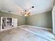 Renovation ready room with a ceiling fan, large window, and view of a staircase at 16006 Armistead Ln, Odessa, FL 33556