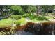 Waterfront property with dock access, surrounded by lush landscaping at 16006 Armistead Ln, Odessa, FL 33556