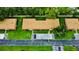 Aerial view of townhomes with well-maintained lawns and carport parking at 1701 Pinehurst Rd # 33E, Dunedin, FL 34698