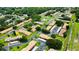 Aerial community view of buildings and shared parking; mature landscaping at 1701 Pinehurst Rd # 33E, Dunedin, FL 34698