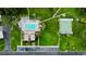 Aerial view of community featuring a pool, shuffleboard court, parking, and green spaces at 1701 Pinehurst Rd # 33E, Dunedin, FL 34698