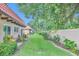 This property features a lush green backyard with a walking path and mature landscaping at 1701 Pinehurst Rd # 33E, Dunedin, FL 34698