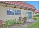 The backyard has a covered patio, lush green plants, and a sliding glass door at 1701 Pinehurst Rd # 33E, Dunedin, FL 34698