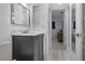 Bathroom featuring a modern vanity, open shelving, and a doorway leading to the bedroom at 1701 Pinehurst Rd # 33E, Dunedin, FL 34698