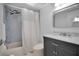 Bathroom with blue tiled shower, updated vanity, and shower with adjustable shower head at 1701 Pinehurst Rd # 33E, Dunedin, FL 34698