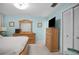 Comfortable bedroom with a wood bed frame, light blue walls, TV on a dresser and closet at 1701 Pinehurst Rd # 33E, Dunedin, FL 34698