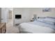 This bedroom includes light gray carpet, a wooden dresser, and a view to the bathroom at 1701 Pinehurst Rd # 33E, Dunedin, FL 34698