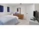 This bedroom includes light gray carpet, a wooden dresser, and is decorated with blue accents at 1701 Pinehurst Rd # 33E, Dunedin, FL 34698