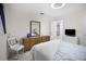 The bedroom includes light gray carpet, a wooden dresser, and a view to the living room and bathroom at 1701 Pinehurst Rd # 33E, Dunedin, FL 34698