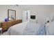 The bedroom has light gray carpet, a wooden dresser, and a view to the living room at 1701 Pinehurst Rd # 33E, Dunedin, FL 34698